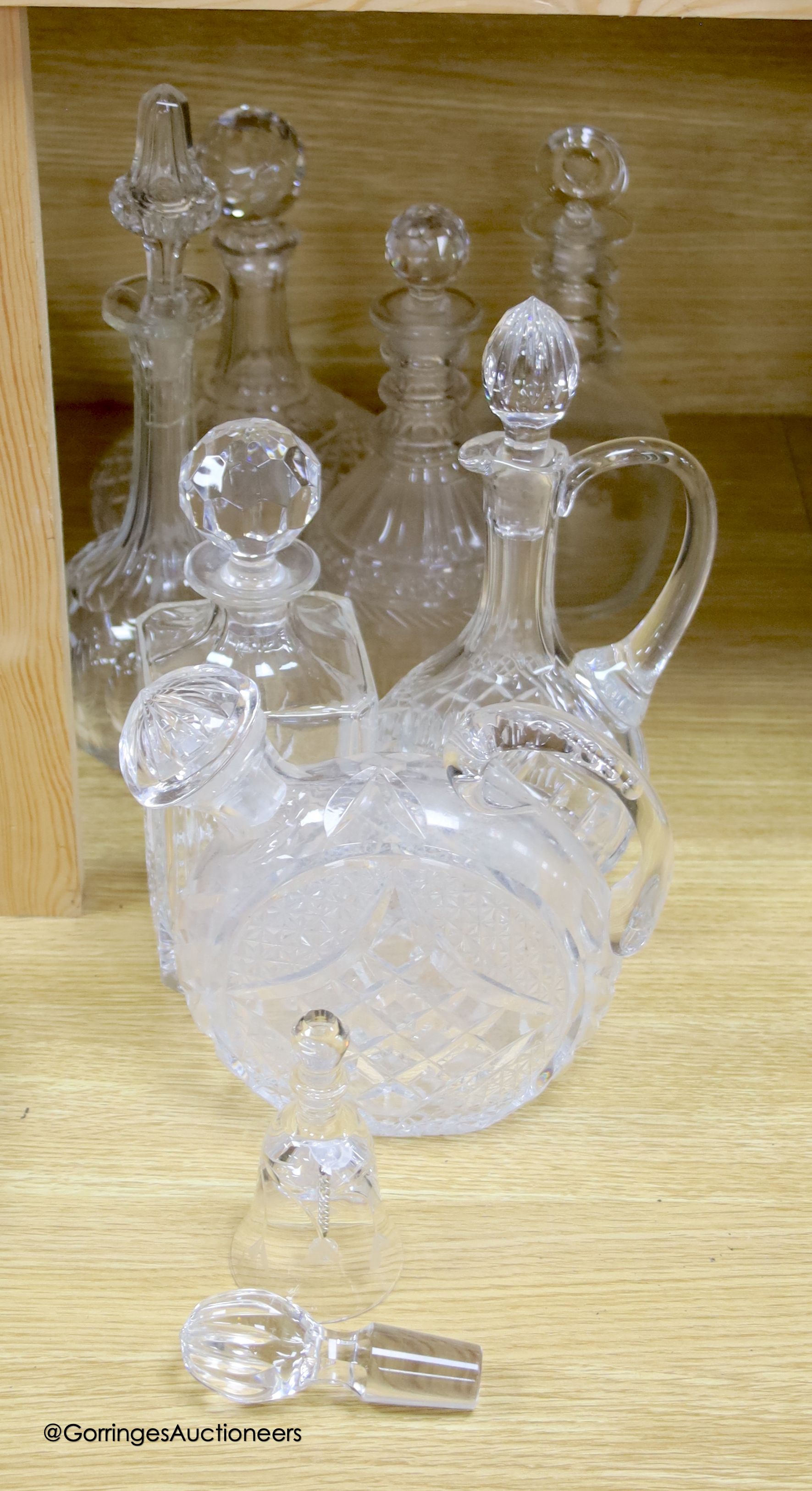 A collection of clear cut glass decanters